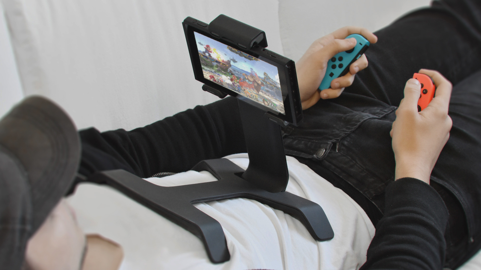 playing switch on the couch with tstand stand